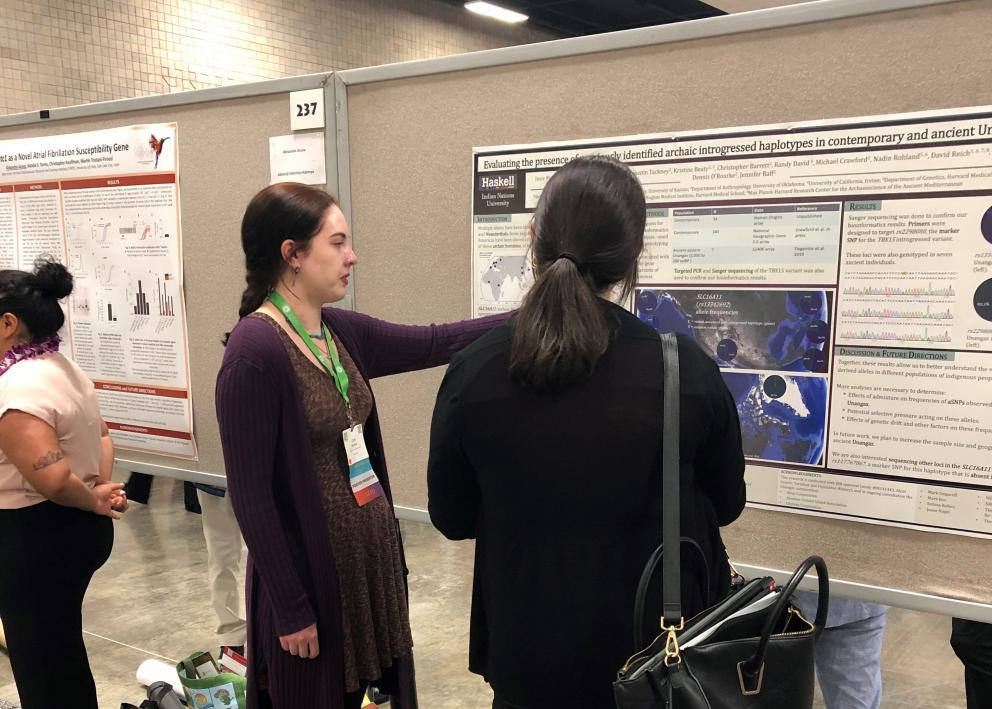 SACNAS Conference presenter discusses their research with conference attendee